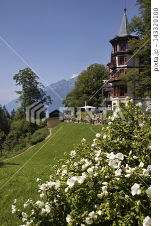 Grand hotel giessbach building surrounded by blooming white flowers 143329100