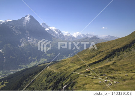 Swiss alps mountains and eiger peak with winding hiking path Swiss alps mountains and eiger peak with winding hiking path 143329108