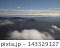 Mountain peaks rising above foggy morning clouds 143329127