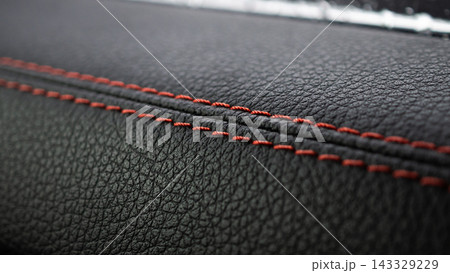 Red stitch on black leather of luxury sports car Red stitch on black leather of luxury sports car 143329229