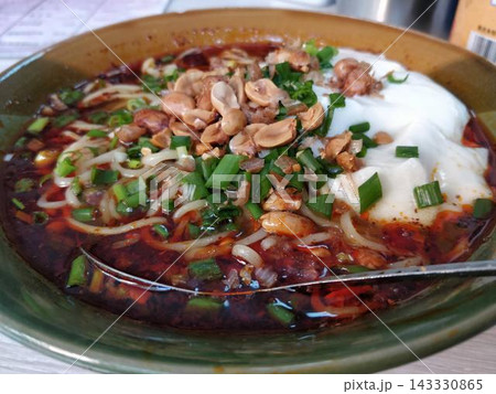 Spicy chinese dandan noodles with peanuts and green onions, Close Up Spicy chinese dandan noodles with peanuts and green onions, Close Up 143330865