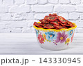 Bowl with dehydrated red fragrant tomatoes with herbs and spices. 143330945