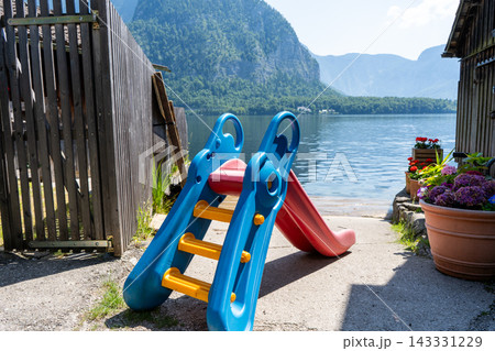 Children Slide on Lake Shore Nature and Water Background in Austria 143331229