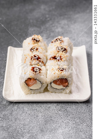 Sushi roll with tuna, rice, and cream cheese, served with soy sauce, wasabi, and ginger. Tuna roll 143331661