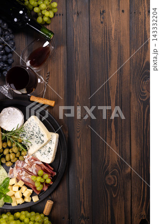 Wine and cheese charcuterie board on rustic wood 143332204