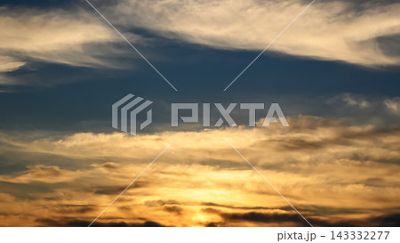 golden sunset with dark contrasting clouds near the horizon line golden sunset with dark contrasting clouds near the horizon line 143332277