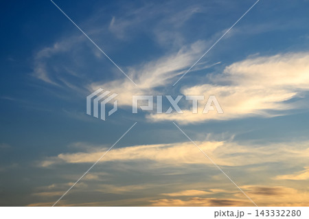gentle evening sky with light cirrus clouds illuminated by the setting sun gentle evening sky with light cirrus clouds illuminated by the setting sun 143332280