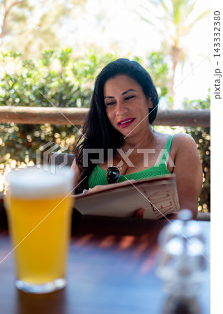 Beautiful Woman Reading Menu At Outdoor Restaurant Terrace Beautiful Woman Reading Menu At Outdoor Restaurant Terrace 143332380