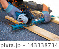Worker cutting metal with many sharp sparks using equipments to cut iron 143338734