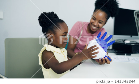 Young girl playing with glove balloon at hospital 143348844