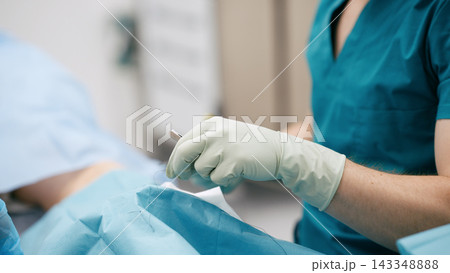 Surgeon performing operation stitching wound in hospital 143348888