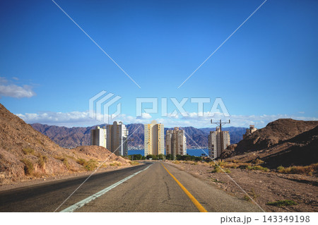 Cityscape on a sunny day. Driving a car on the road in the desert. The way to Eilat. View the beautiful mountain landscape and the city of Eilat from the windscreen. Israel Southern Israel 143349198
