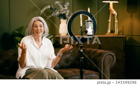 Woman creating online content with a ring light Woman creating online content with a ring light 143349298
