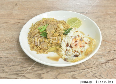 spicy fried rice beef meat with kale couple lemon topping egg on plate 143350164