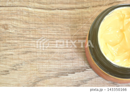 close up of yellow face cream packaging in glass bottle on table close up of yellow face cream packaging in glass bottle on table 143350166