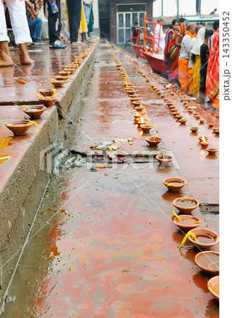 Oil Lamps (Diyas) Lined Along River Ghat During Ritual in Mathura 143350452
