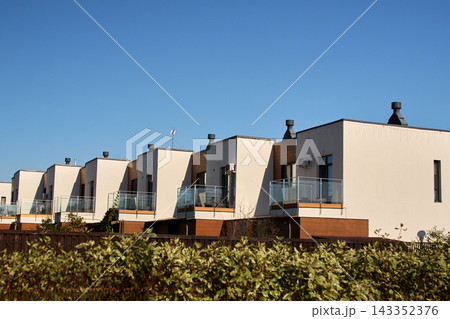 Modern Townhouse Units with Glass Balconies on Sunny Day Modern Townhouse Units with Glass Balconies on Sunny Day 143352376