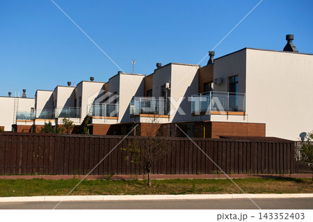 Row of Modern Suburban Townhouses with Glass Balconies Row of Modern Suburban Townhouses with Glass Balconies 143352403