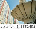 Decorative Park Bench and Tiered Fountain on Paved City Plaza 143352452