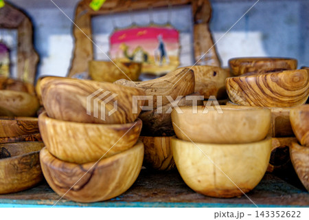 Stacked Handcrafted Olive Wood Salad Bowls in a Tunisian Market Shop 143352622