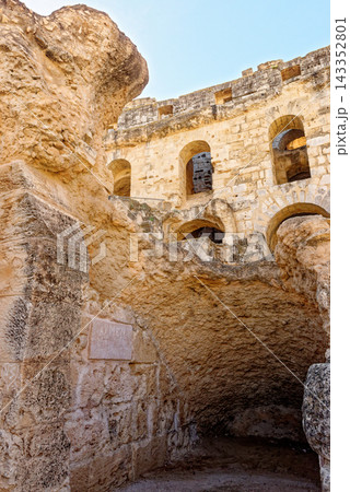 Tracking Shot of MultiTiered Arched Arena Wall and Weathered Stone Foundations inside El Jem Amphitheatre Tracking Shot of MultiTiered Arched Arena Wall and Weathered Stone Foundations inside El Jem Amphitheatre 143352801