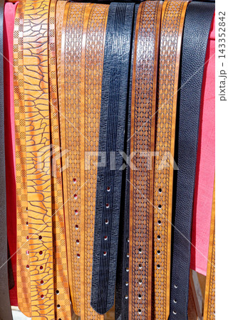 Close Up Full Frame Texture Shot of Assorted Embossed and Patterned Genuine Leather Belts 143352842