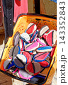 Colorful Souvenir Leather Coin Purses Piled Inside a Plastic Display Basket 143352843