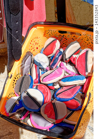 Colorful Souvenir Leather Coin Purses Piled Inside a Plastic Display Basket Colorful Souvenir Leather Coin Purses Piled Inside a Plastic Display Basket 143352843