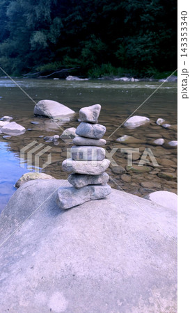Stacked Stones on the Bank of a Mountain River Stacked Stones on the Bank of a Mountain River 143353340