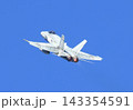 CF-18 Hornet Air Force fighter aircraft flying on a blue sky background 143354591