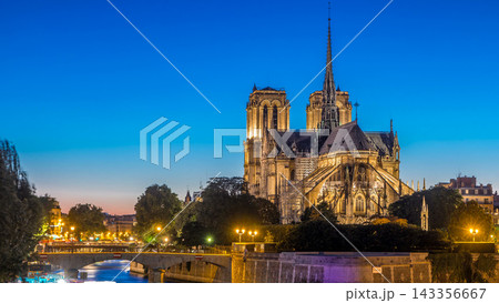 Rear view of Notre Dame De Paris cathedral day to night timelapse after sunset. 143356667
