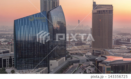 Dubai downtown street with busy traffic and skyscrapers around night to day timelapse. Dubai downtown street with busy traffic and skyscrapers around night to day timelapse. 143356725