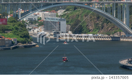 Passengers in a cruise on the Douro river in Tourist boat in Porto, Portugal timelapse 143357005