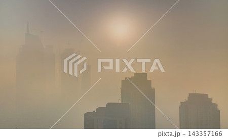 Foggy morning sunrise in downtown of Dubai timelapse. 143357166