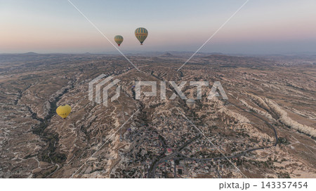 Aerial view from hot air balloon during Sunrise over the fairytale landscape hills of Kapadokya timelapse hyperlapse with morning light. Aerial view from hot air balloon during Sunrise over the fairytale landscape hills of Kapadokya timelapse hyperlapse with morning light. 143357454