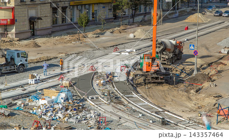 Concrete works for road construction with many workers and mixer timelapse 143357464
