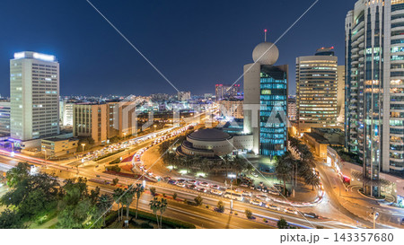 Dubai Creek area surrounded by modern buildings and busy traffic street day to night timelapse Dubai Creek area surrounded by modern buildings and busy traffic street day to night timelapse 143357680