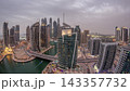 Aerial view of Dubai Marina residential and office skyscrapers with waterfront day to night timelapse 143357732