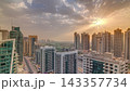 Sunrise view of various skyscrapers and towers in Dubai Marina from above aerial timelapse 143357734