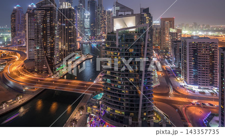 Aerial view of Dubai Marina residential and office skyscrapers with waterfront day to night timelapse 143357735