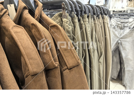 Trendy autumn clothing collection displayed in a modern retail store 143357786