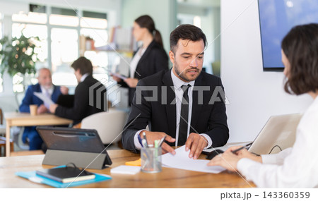 Bank manager talking with female client in office 143360359