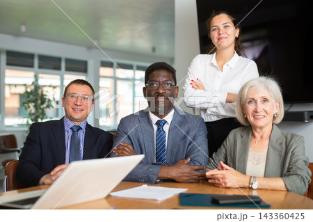 Group of different people posing at table in office 143360425