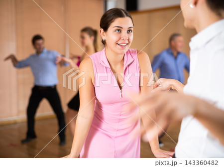Young girl enjoying practicing twist in dance studio Young girl enjoying practicing twist in dance studio 143360482