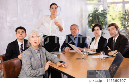 Mature female entrepreneur watching presentation during business training 143360507