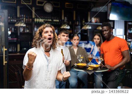 Greece football team fan spending time in bar Greece football team fan spending time in bar 143360622