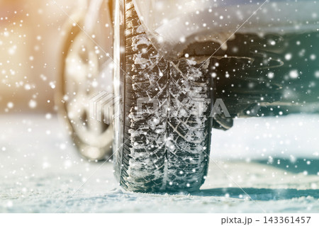 Close-up of car wheels rubber tires in deep winter snow. Transportation and safety concept. Close-up of car wheels rubber tires in deep winter snow. Transportation and safety concept. 143361457