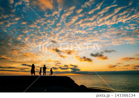 宮古島の夕暮れの海辺に立つ家族と空いっぱいに広がる雲の風景 宮古島の夕暮れの海辺に立つ家族と空いっぱいに広がる雲の風景 143366134