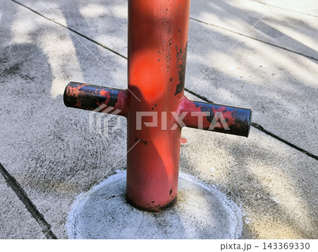 Weathered Red Metal Post on Concrete 143369330
