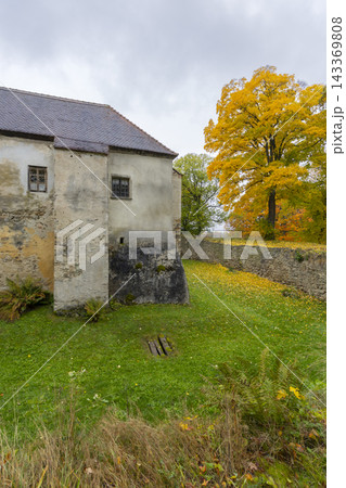 Nove Hrady castle wall and vibrant autumn tree 143369808